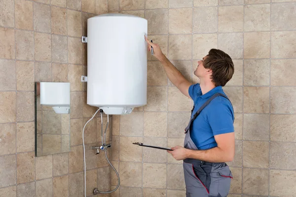 Plumber checking electric boiler and water heater in Broadalbin NY