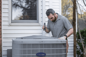 Technician evaluating when to replace an air conditioner in Johnstown NY