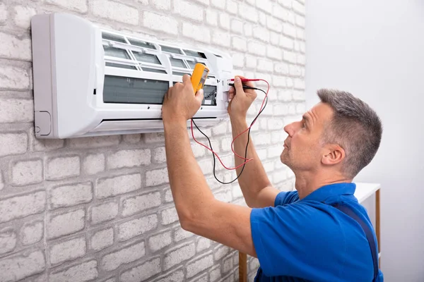 depositphotos_242671330-stock-photo-male-electrician-checking-air-conditioner